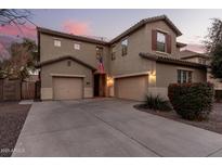 Two-story house with attached garage, landscaping, and a flag at 739 E Lovebird Ln, Gilbert, AZ 85297