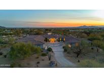 Expansive desert home with beautiful tile roof, long private driveway, and amazing mountain views at sunset at 9045 E Chino Dr, Scottsdale, AZ 85255