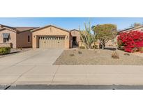 Single-story home with desert landscaping and two-car garage at 12750 W Jasmine Trl, Peoria, AZ 85383