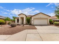 Inviting single-story home featuring a two-car garage and low-maintenance desert landscaping at 12937 W Highland Ave, Litchfield Park, AZ 85340