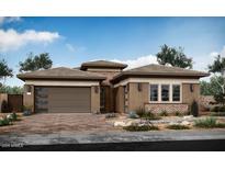 Modern home exterior with brown stucco and a three-car garage at 1436 E Cherrywood Pl, Chandler, AZ 85249