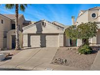 Inviting exterior view of home featuring a two-car garage and desert landscaping at 15858 S 11Th Pl, Phoenix, AZ 85048