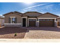 Charming single-story home showcasing a well-manicured front yard and inviting curb appeal at 17585 W Blue Sky Dr, Surprise, AZ 85387