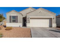 Charming single-story home featuring neutral stucco, a two-car garage, and desert landscaping at 3481 N 309Th Ln, Buckeye, AZ 85396