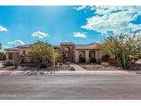 Single-story home with stone accents and landscaped yard at 3633 E Encanto St, Mesa, AZ 85205