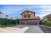 Two-story house with a two-car garage and well-manicured landscaping at 4923 E Paradise Ln, Scottsdale, AZ 85254