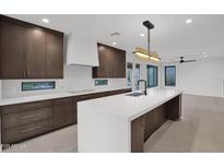 Modern kitchen with island, stainless steel appliances, and dark wood cabinets at 6216 W Molly Dr, Phoenix, AZ 85083