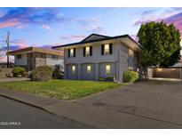 Two-story house with gray exterior, landscaping, and driveway at 6547 N 3Rd Ave, Phoenix, AZ 85013
