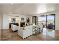 Spacious living room with fireplace and access to balcony at 7181 E Camelback Rd # 904, Scottsdale, AZ 85251