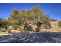 Desert landscape surrounds this charming single-story home with a two-car garage at 7500 E Boulders Pkwy # 23, Scottsdale, AZ 85266