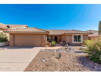 Single-story home with desert landscaping and a two-car garage at 8637 E Golden Cholla Cir, Gold Canyon, AZ 85118