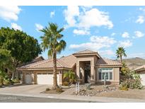 Single-story home with tile roof, two-car garage, and desert landscaping at 1714 E Saltsage Dr, Phoenix, AZ 85048