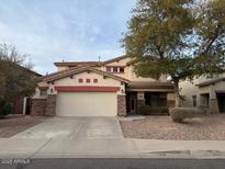 Two-story house with a large garage and landscaped front yard at 17322 W Carmen Dr, Surprise, AZ 85388