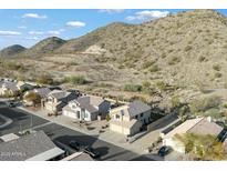 Aerial view of a house in a residential area with desert landscape in the background at 20443 N 17Th Way, Phoenix, AZ 85024