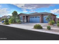 Charming single-story home featuring a 3-car garage and landscaped front yard at 40538 W Crane Dr, Maricopa, AZ 85138