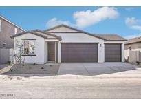 New construction home with a two-car garage and neutral exterior at 4235 E Brook Lynn Pl, San Tan Valley, AZ 85143