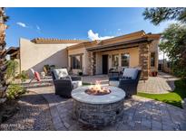 Relaxing backyard patio with fire pit and seating area at 6202 E Mckellips Rd # 117, Mesa, AZ 85215