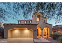 Charming home featuring a two-car garage and an inviting front porch with seating at 9305 E Canyon View Rd, Scottsdale, AZ 85255