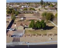 Aerial view of a ranch-style house with a large yard and gated entrance at 14040 E Ocotillo Rd, Chandler, AZ 85249