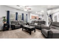 Spacious living room with two sofas, a coffee table, and carpet flooring at 18320 N Betty Ct, Maricopa, AZ 85138