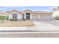 Single-story home with two-car garage and landscaped front yard at 2303 E San Tan St, Chandler, AZ 85225