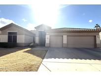 Tan two-story house with two-car garage and landscaped yard at 2303 E San Tan St, Chandler, AZ 85225