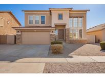 Charming two-story home with a neutral color scheme, stone accents, and a well-manicured yard at 3091 E Morenci Rd, San Tan Valley, AZ 85143