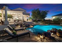 Luxury home boasts a stunning pool with rock features, a bridge, and built-in grill for ultimate outdoor entertaining at 31048 N 56Th St, Cave Creek, AZ 85331