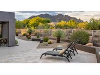 Relaxing patio with mountain views and comfortable lounge chairs at 33974 N 66Th Way, Scottsdale, AZ 85266