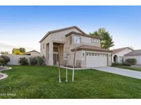 Two-story house with attached garage and well-manicured lawn at 671 N Coral Key Ave, Gilbert, AZ 85233