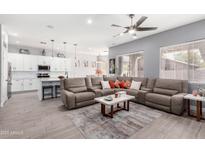 Open living room with large sectional sofa and kitchen views at 7231 W Sandra Ter, Peoria, AZ 85382