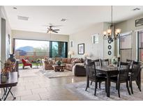 Open living space with a view, tile floors, and sliding doors to backyard at 8961 E Ivyglen St, Mesa, AZ 85207