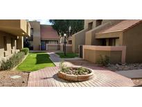 Well-maintained courtyard with brick walkways and lush landscaping at 1432 W Emerald Ave # 647, Mesa, AZ 85202