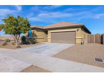Single-story home with a two-car garage and desert landscaping at 18492 W Via Del Sol --, Surprise, AZ 85387