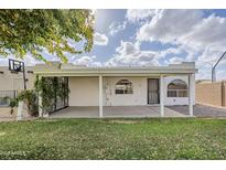 Covered patio with grassy backyard and basketball hoop at 2055 N Recker Rd, Mesa, AZ 85215