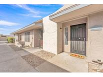 Inviting front exterior with neutral stucco, covered entry, and low maintenance rock landscaping at 2533 W Hazelwood St # 3, Phoenix, AZ 85017