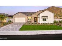 Stunning curb appeal with a two-car garage and landscaped lawn at 33608 N Maverick Mountain Trl, San Tan Valley, AZ 85144