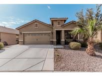 Single-story home with two-car garage and desert landscaping at 514 S 224Th Dr, Buckeye, AZ 85326