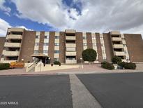 Sunland Towers Condominium building exterior, multiple stories, with parking lot at 515 S Parkcrest -- # 531, Mesa, AZ 85206