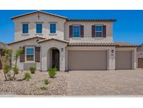 Charming two-story home boasts a three-car garage, desert landscaping, and a stylish mix of stucco and tile accents at 12362 W Marguerite Ave, Avondale, AZ 85323