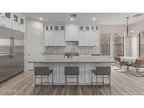 Spacious kitchen with white cabinets, large island, and stainless steel appliances at 18196 N 92Nd St, Scottsdale, AZ 85255