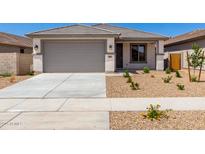 Charming single-story home featuring a two-car garage, landscaped front yard and neutral color palette at 18366 W Poston Dr, Surprise, AZ 85387