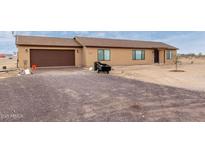 Newly built home with a brown garage door and desert landscaping at 31515 W Buchanan St, Buckeye, AZ 85326