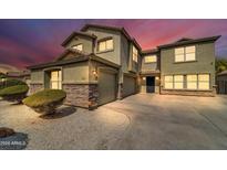 Two-story house with a large driveway and landscaping at 4628 W Hasan Dr, Laveen, AZ 85339
