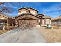 Two-story house with a brown facade, driveway, and desert landscaping at 728 E Lovegrass Dr, San Tan Valley, AZ 85143