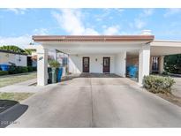 Front view of charming house with carport and well-manicured lawn at 920 W Solcito Ln, Phoenix, AZ 85013