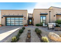Modern home with landscaped front yard, two-car garage, and inviting entryway at 12451 E Troon Vista Dr, Scottsdale, AZ 85255