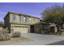 Two-story house with a neutral color scheme and a three-car garage at 1326 E Cecil Ct, Casa Grande, AZ 85122
