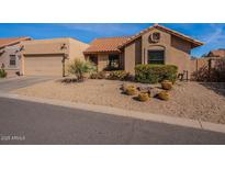 Charming single-story home with desert landscaping and a two-car garage at 14637 N Olympic Way, Fountain Hills, AZ 85268