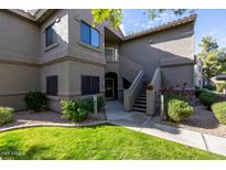 Attractive condo building exterior with landscaping and stairs at 15225 N 100Th St # 1208, Scottsdale, AZ 85260